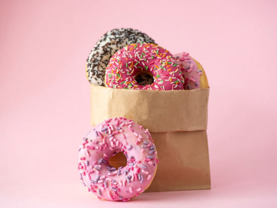 four-donuts-with-glaze-paper-bag