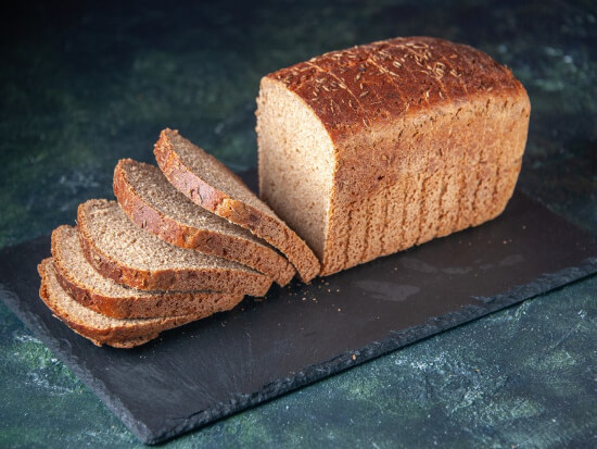 front-view-black-bread-slices-black-board-mixed-colors-distressed-background