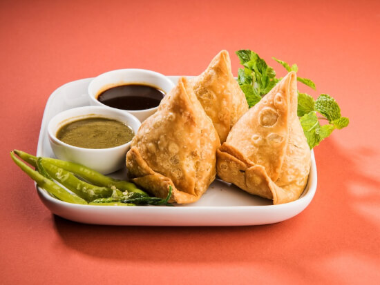 veg-samosa-is-indian-popular-snack-junk-food-served-with-fried-green-chilly-onion-chutney-ketchup